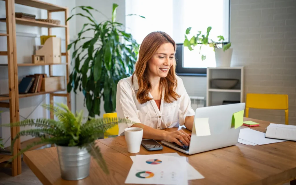 Freelancer managing client projects with laptop workspace - best project tracking tools