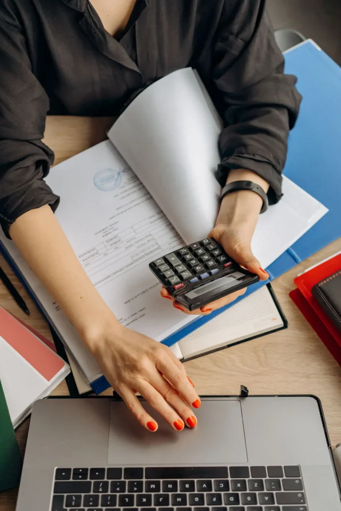 Diy client onboarding automation vs paying $120–$150 for it on upwork 12 Diy costs - laptop and calculator on a desk.